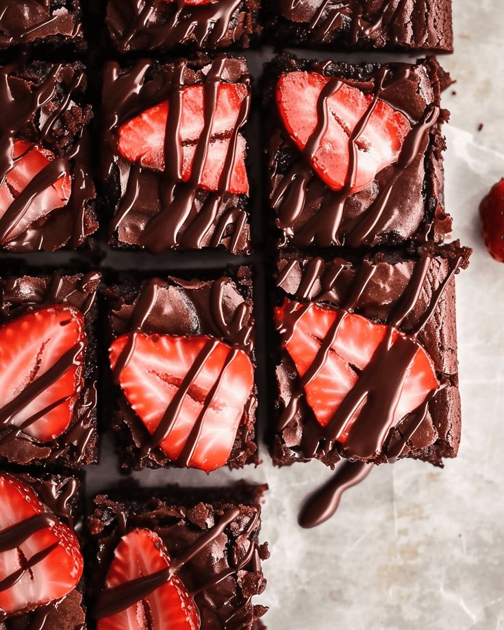 chocolate brownies with strawberries on top and drizzled in melted chocolate