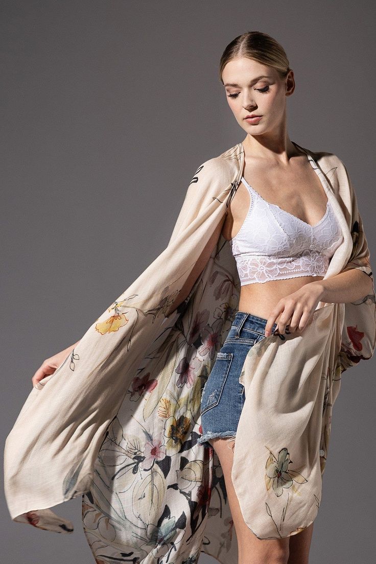 Elevate your style with the Urbanista Northbrook Kimono. Crafted from 100% viscose, this lightweight floral garment features delicate patterns in soft, feminine hues. Add an elegant touch to any outfit with its flowy silhouette and approximate measurements of L 38" W 40". Chic Floral Print Kimono For Brunch, Spring Silk Kimono For Daywear, Chic Floral Print Kimono For Daywear, Bohemian Cream Kimono For Spring, Cream Bohemian Kimono For Spring, Cream Wrap Kimono For Spring, Chic Floral Print Summer Kimono, Casual Silk Kimono For Spring, Casual Silk Spring Kimono