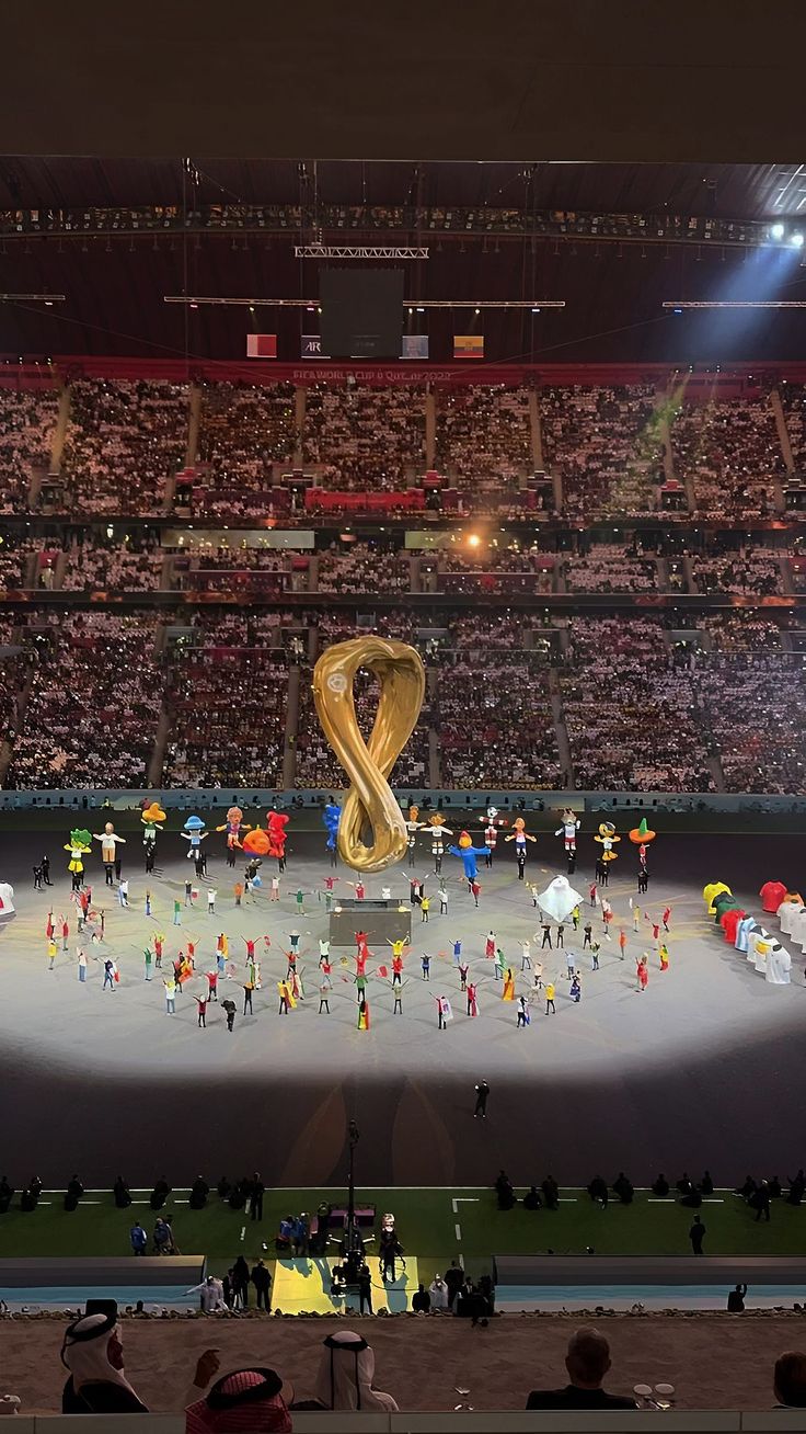 an olympic ceremony is being performed in front of a crowd at the olympics opening ceremony