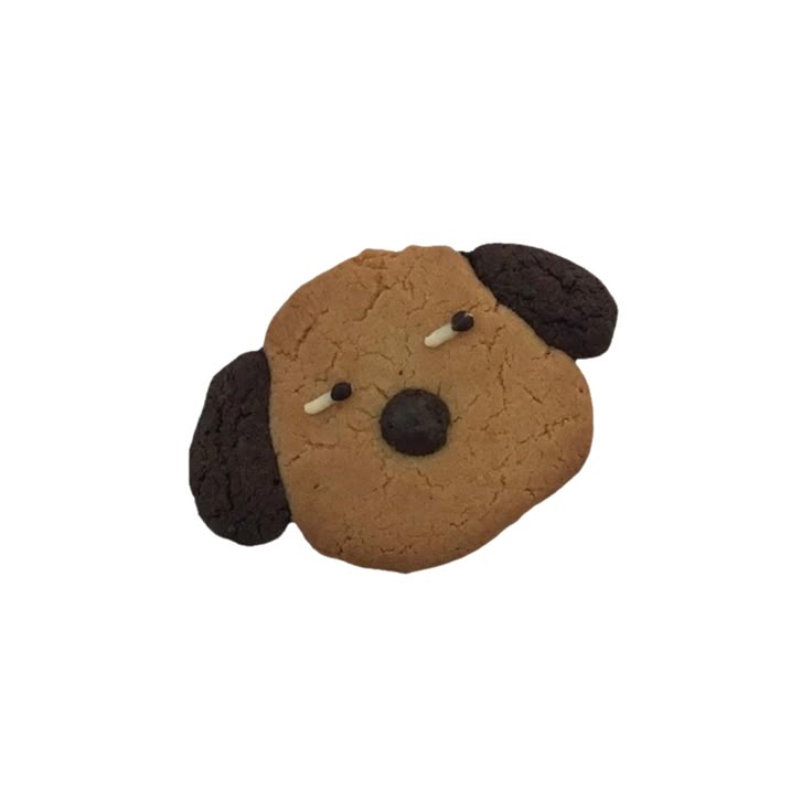 a cookie shaped like a dog with its eyes closed