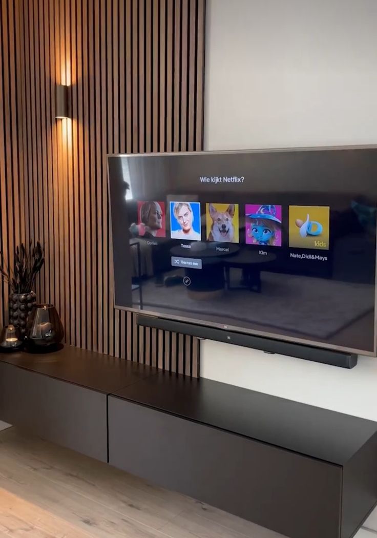 a flat screen tv sitting on top of a wooden entertainment center