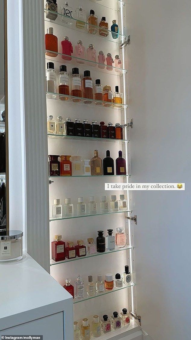 the shelves in this bathroom are filled with different types of perfumes and cologne bottles