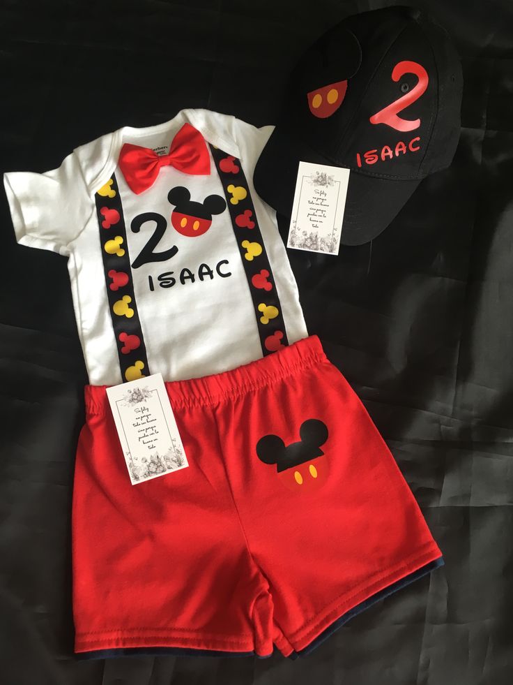 a mickey mouse outfit and hat are on display