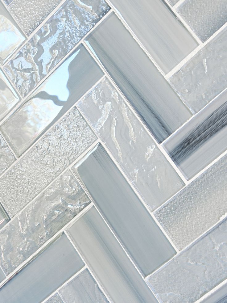 a close up view of a tile wall with white and gray squares on the bottom