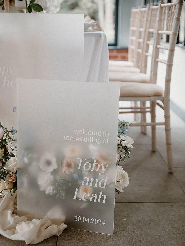 a couple of white chairs sitting next to each other on top of a cement floor