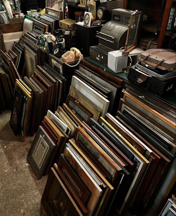 a room filled with lots of different types of furniture and electronics on display in front of a window