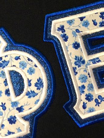 the letters p and f are decorated with blue flowers