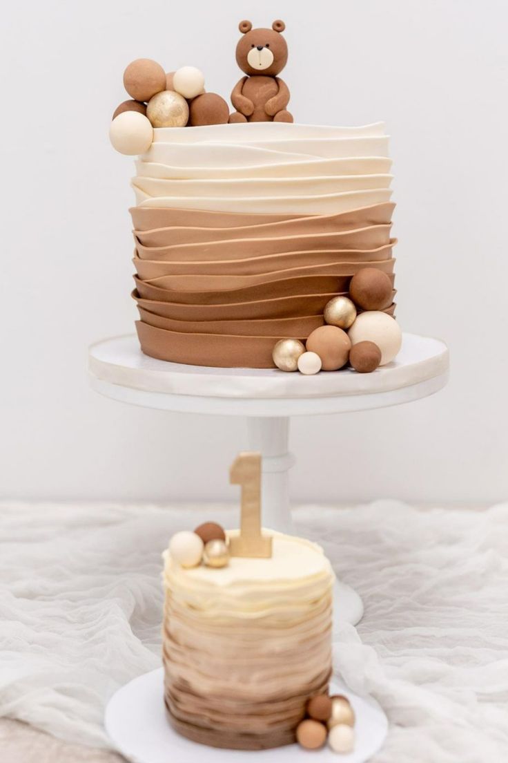 two tiered cake with teddy bears on top