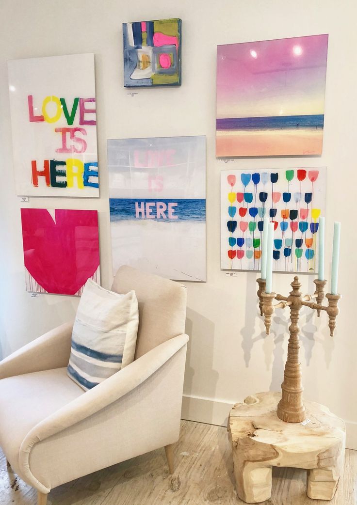 a living room filled with furniture and pictures on the wall