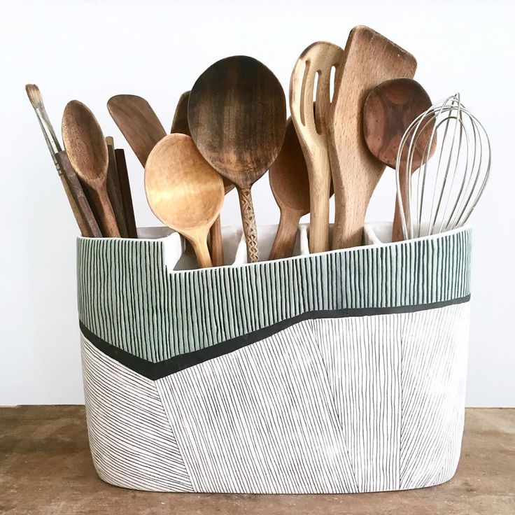 wooden spoons and whisks are in a basket