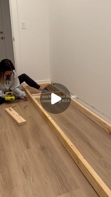 a person laying on the floor with some wood