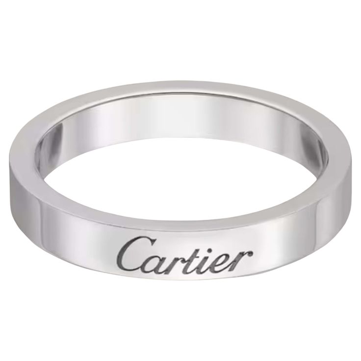 a white gold ring with the word carrier engraved on it