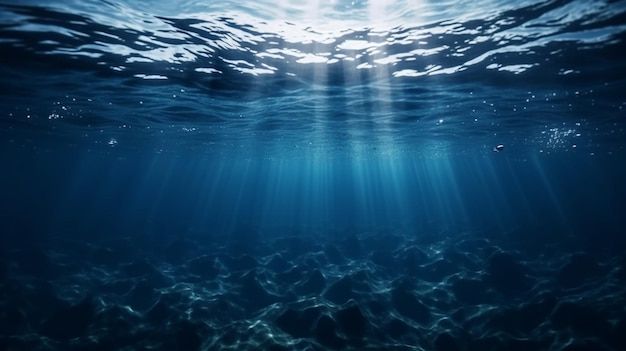 an underwater view of the ocean with sunlight coming through the water's surface and light shining down on it