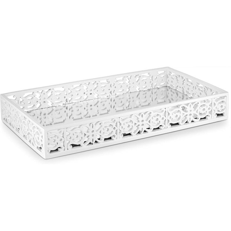 a white tray with intricate designs on the front and sides, sitting on a white surface