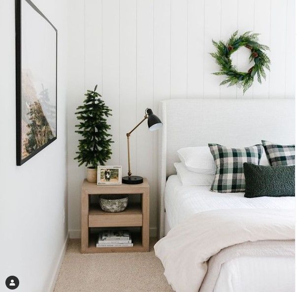 a bedroom with white walls and green accents