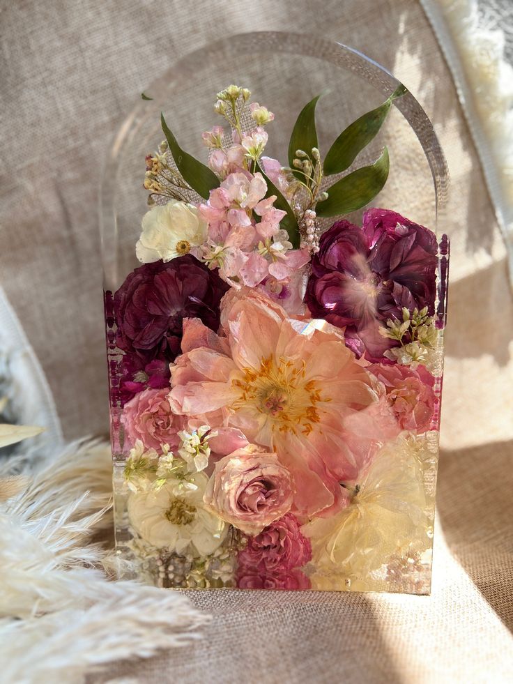 a vase filled with lots of flowers on top of a chair