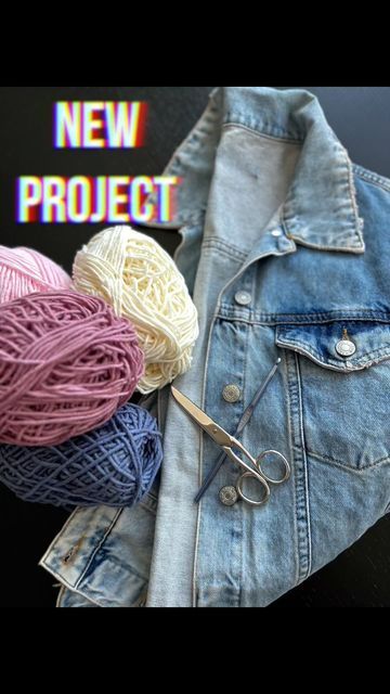 several balls of yarn sitting next to a jean jacket