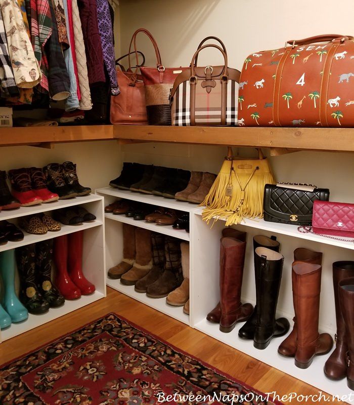 the closet is filled with many purses and handbags