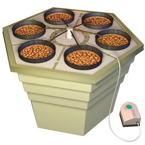 a stove top with six pans filled with food next to a remote control unit