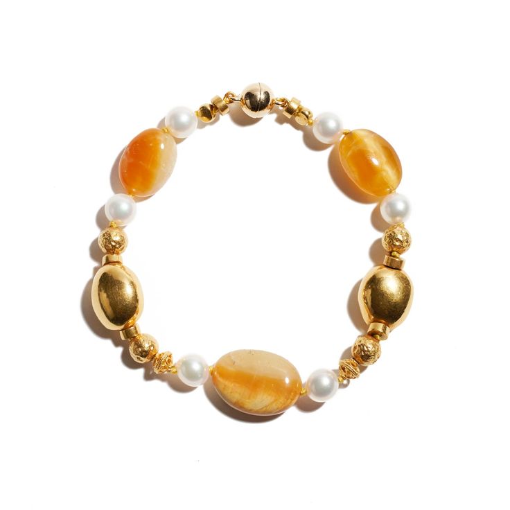 18K yellow gold, cabochon golden opal, pearl Across a medley of rich golds and yellows, Ann Ziff joins a beautiful assemblage in varying shapes and hues. Exquisite gemstones sparkle harmoniously in this delicate, yet dynamic bracelet. Interlocking high karat gold, cabochon golden opals, luminous pearls, this bracelet will drape over your wrist with unparalleled comfort and dazzling opulence. The artist creates a distinctive design as an expression to satisfy the soul. All the while, admiring the Yellow Gold Pearl Bracelets With Pearl Charm, Luxury Yellow Gold Pearl Bracelet, Luxury Gold Plated Yellow Gold Pearl Bracelet, Luxury Yellow Gold Pearl Bracelet With Charm, Yellow Gold-plated Bracelet With Pearl Charm, Gold Wood, Quartz Ring, Quartz Earrings, Rutilated Quartz