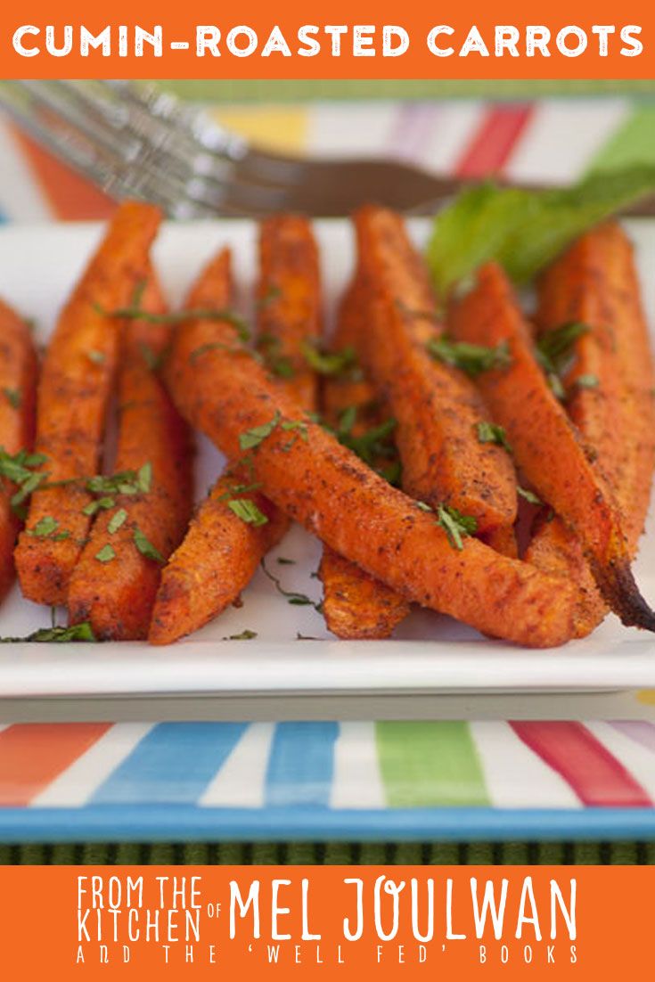 some carrots are on a plate with a fork