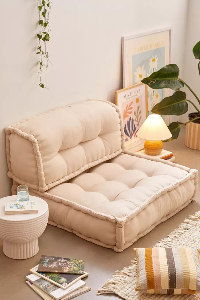 a living room filled with furniture and plants