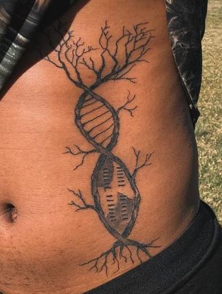 a person with a tattoo on their stomach that has an image of a tree growing out of it