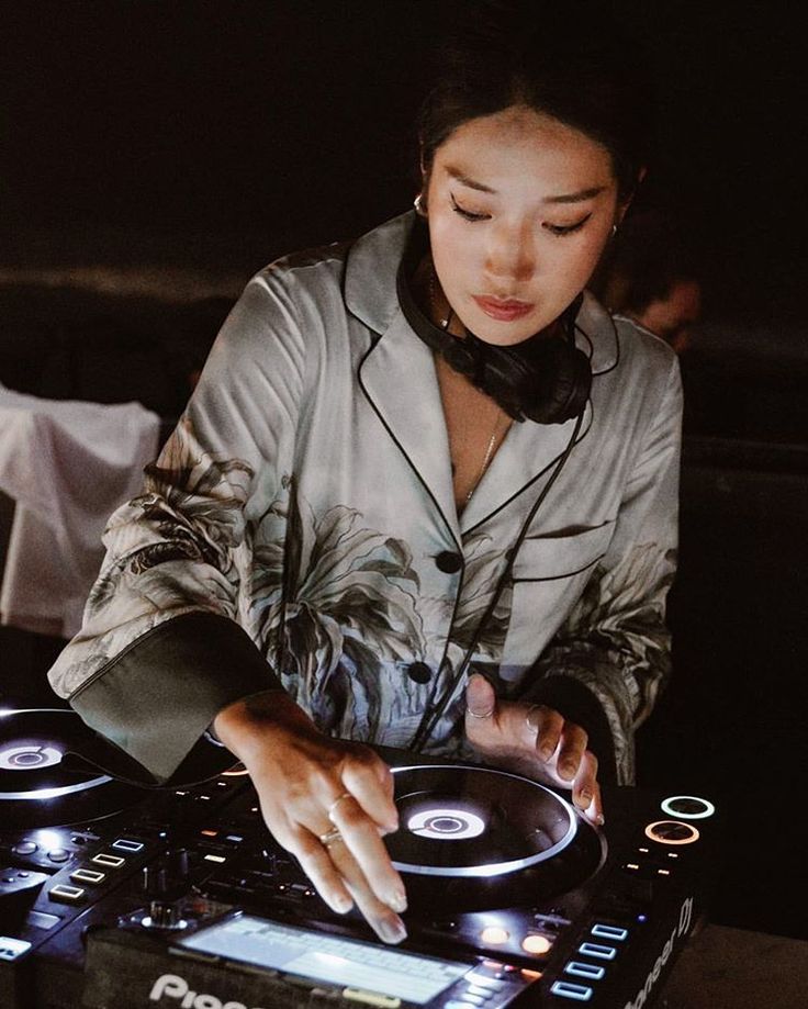 a woman is playing music on her turntable