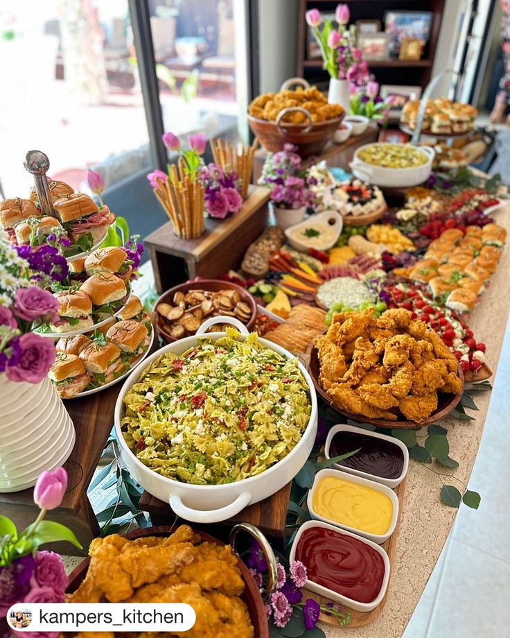 a buffet table filled with lots of food and condiments on top of it