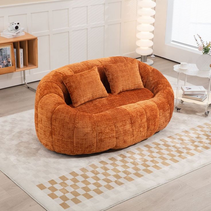 a living room filled with furniture and a large round chair on top of a rug