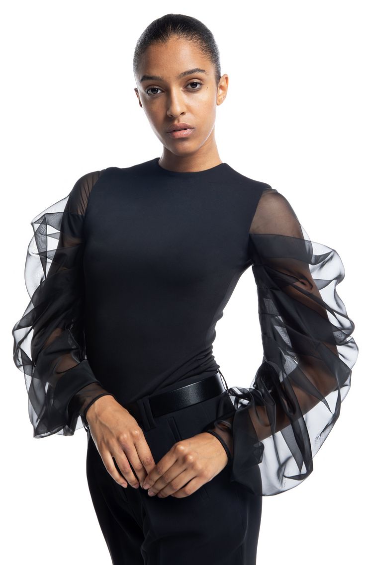 Preorder If Your Size Is Not Available. We'll Ship Within 7-10 Days. Styling: Tolemee is an elegant draped sleeve top. The fitted body is lined in the self-fabric for extra cover and comfort. The oversized sheer silk sleeves ensure you will steal all the attention every time you wear it. This is a versatile piece you can wear with skirts or pants. A true wardrobe staple you will enjoy for years to come. It looks great here worn over our Endless pants. Fit: The top is fitted, true to size, and th Black Fitted Mesh Top For Evening, Chic Fitted Mesh Top With Sheer Sleeves, Stretch Mesh Top With Sheer Sleeves For Evening, Stretch Mesh Top With Mesh Sleeves For Evening, Fitted Tops With Mesh Puff Sleeves, Sheer Puff Sleeve Blouse For Night Out, Elegant Fitted Mesh Top With Mesh Sleeves, Elegant Fitted Top With Mesh Sleeves, Puff Sleeve Blouse With Sheer Sleeves For Night Out