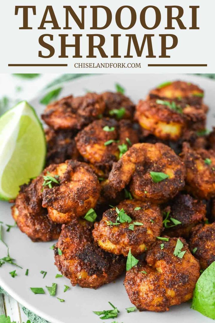 a white plate topped with crab cakes and lime wedges