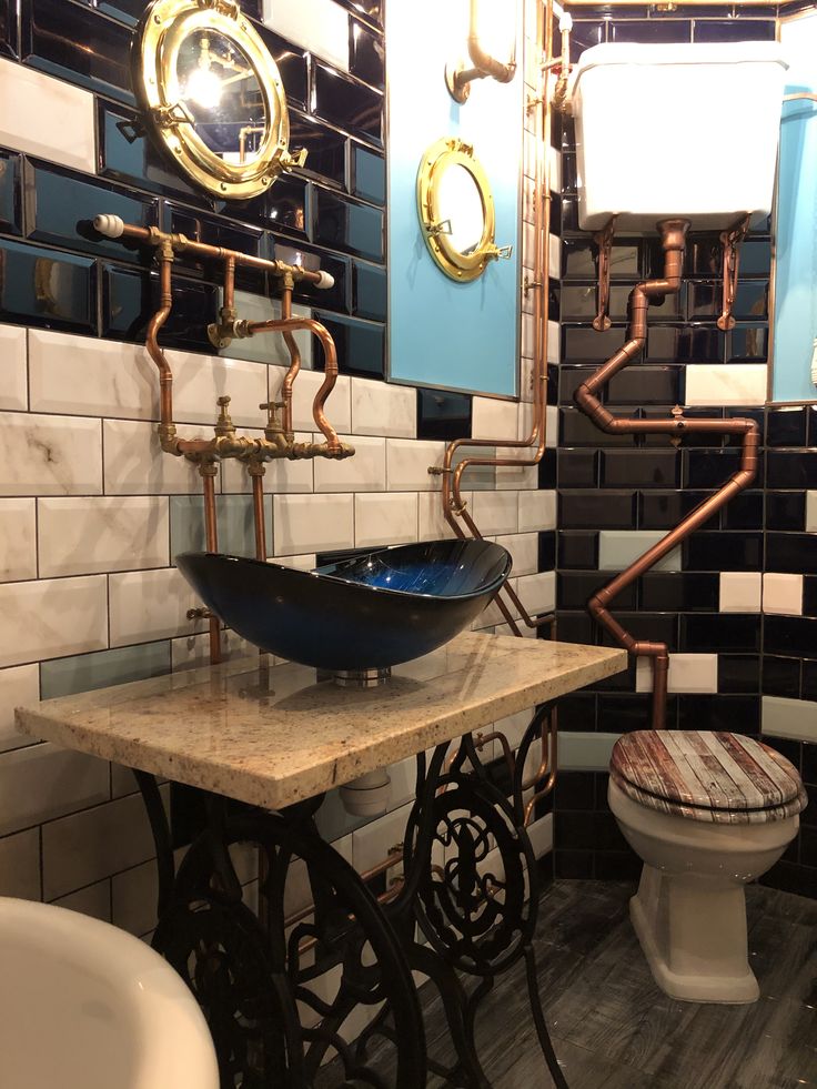 a bathroom with a sink, toilet and pipes