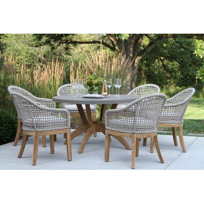 an outdoor table with four chairs around it