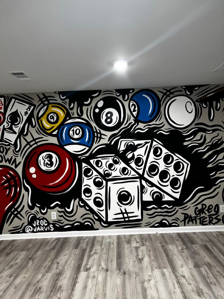 an empty room with a large mural on the wall