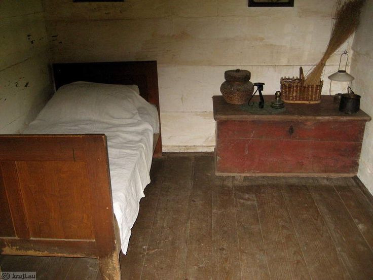 an old bedroom with wooden floors and white walls