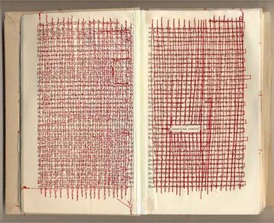 an open book with red thread on the pages and two rows of writing in it