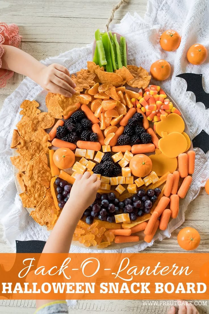 a halloween snack board with jack - o - lantern faces made out of fruit and veggies