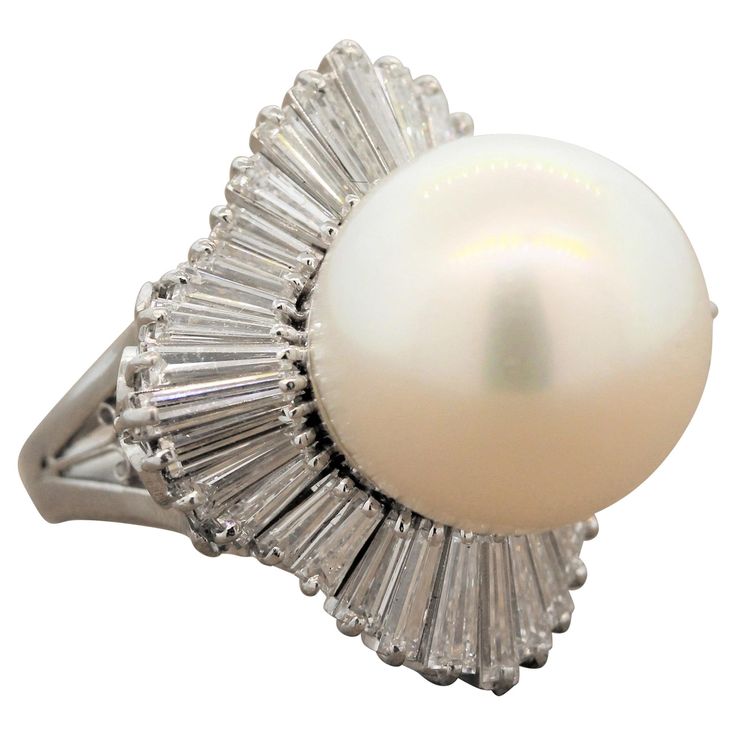 A 14.5mm South Sea pearl takes center stage in this superb estate ring. The platinum setting features fine filigree work encircling the ballerina style halo of this ring with 3.24 carats of VS quality baguette cut diamonds. Ring Size 6 (Sizable) Diamond And Pearl Ring, Vintage Cluster Ring, Baguette Diamond Ring, Ring Pearl, Platinum Earrings, Baguette Diamond Rings, Jewelry Design Inspiration, Pearl And Diamond Ring, Platinum Diamond Rings