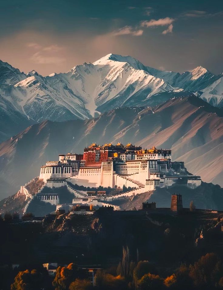 the potala palace in tibet is surrounded by snow - capped mountains