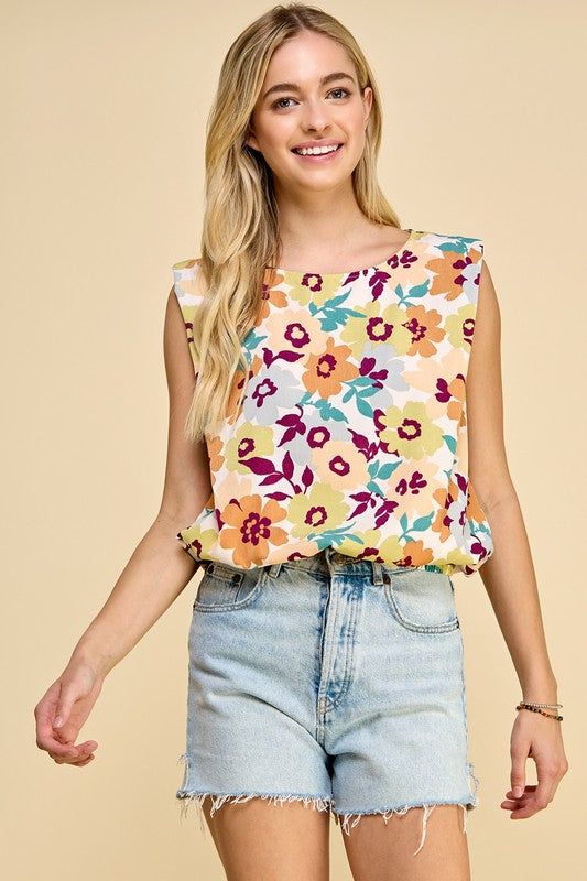 Sleeveless floral print top with elastic band at the bottom 100% Polyester Chic Floral Print Tank Top For Vacation, Multicolor Floral Print Tank Blouse, Multicolor Sleeveless Blouse Tank Top For Day Out, Chic Floral Print Tank Top For Beach, Sleeveless Summer Tops With Elastic Waistband, Patterned Sleeveless Summer Blouse, Spring Sleeveless Floral Print Tops, Floral Print Sleeveless Tops For Spring, Sleeveless Floral Print Tops For Spring