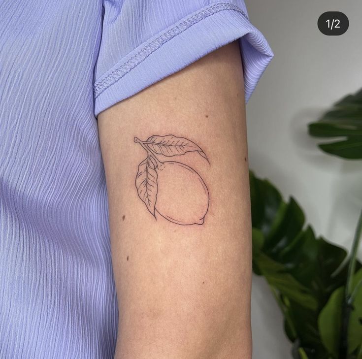 a small peach tattoo on the left arm