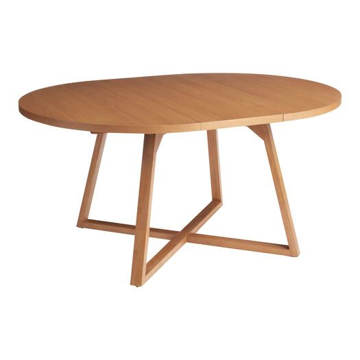 an oval wooden table with two crossed legs