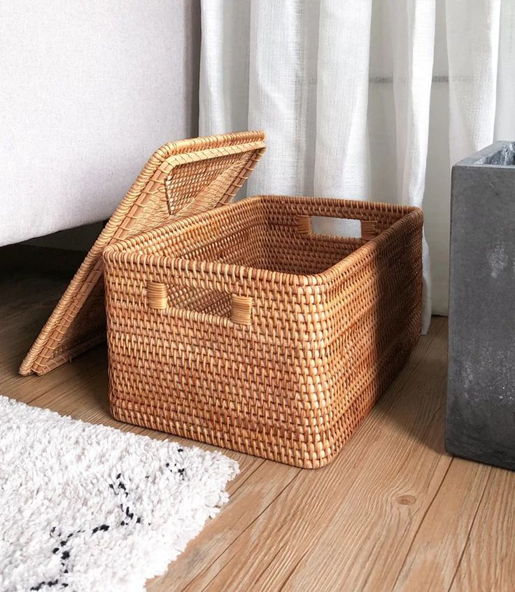 two baskets sitting on the floor next to each other