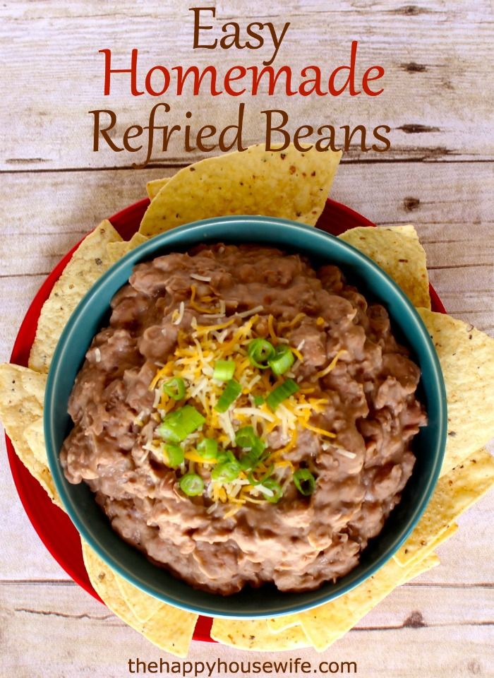 an easy homemade refried beans dip in a bowl with tortilla chips