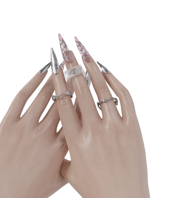 a woman's hands with silver and pink manicures on their nails, both holding onto each other