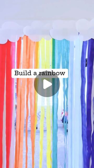 rainbow streamers hanging from the ceiling with words build a rainbow written on one side