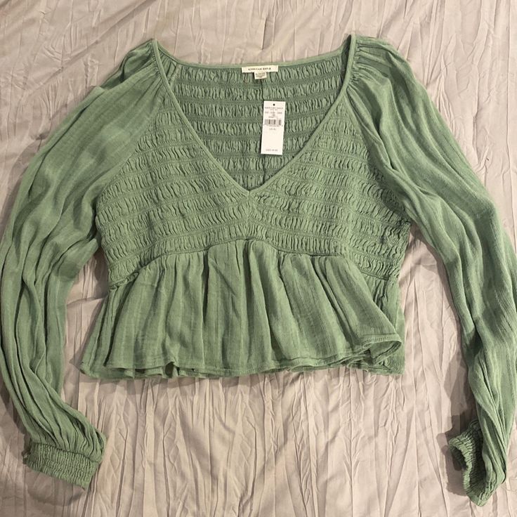 Sage / Light Green A Bay Doll Style Top Cute Long Sleeve Tops For Spring, Cute Long Sleeve Spring Tops, Green Casual Long Sleeve Top For Spring, Casual Green Long Sleeve Top For Spring, Cute Long Sleeve Summer Tops, Cute Fitted Long Sleeve Tops, Cute V-neck Top For Fall, Casual Long Sleeve Top With Ruffles For Spring, Cute Green Relaxed Fit Top