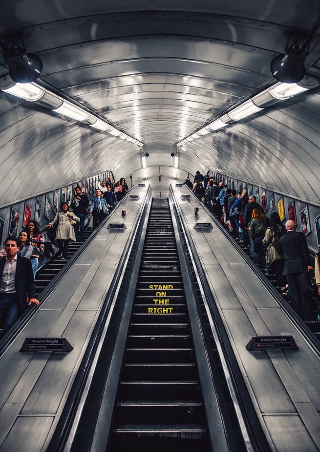 an escalator with many people on it