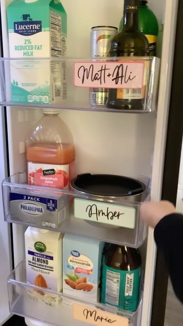 the refrigerator door is open and there are many food items in its bins on it